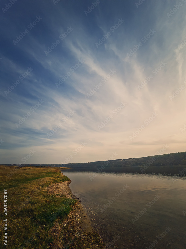 Scenic view to the riverbank of Nistru river, Moldova. Vertical background, calm water flowing. Natural landscape, silent empty place