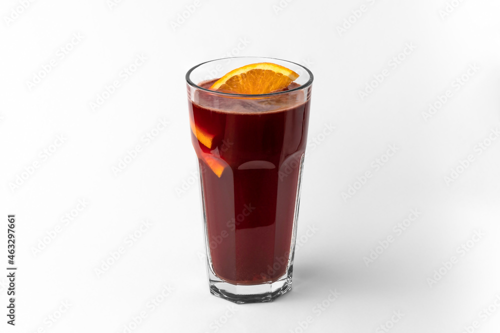 transparent glass of dark red refreshing winter drink mulled wine with sliced orange isolated on a white and gray background with natural shadow transparent glass of dark red refreshing winter drink mulled wine with sliced orange isolated on a white and gray background with natural shadow