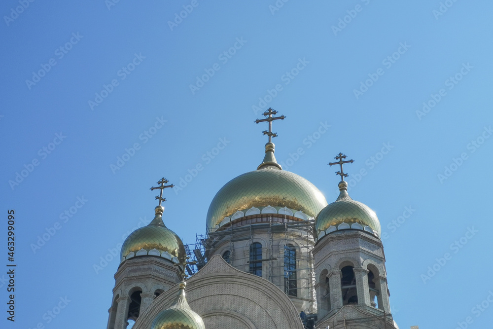 The building of the temple under construction against the blue sky.