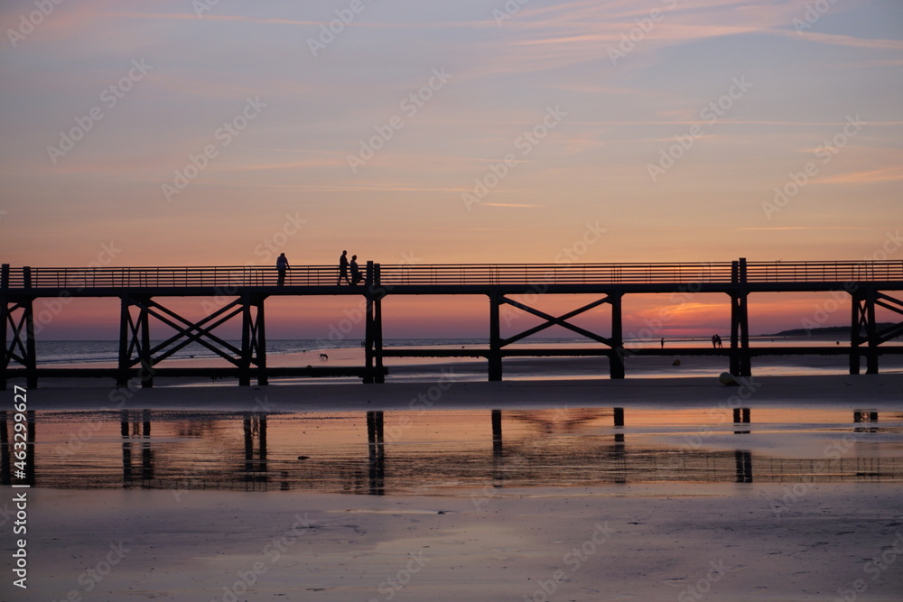 sunset on the  old wooden pier on west coast france