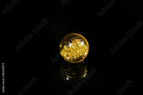 beads with golden sequins on a black mirror background
