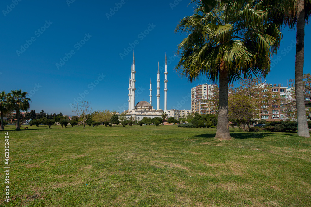 Impressive white Ottoman architecture mosque with 6 towering minarets seen from the surrounding park