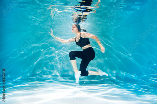 Running woman jogging. Girl under water, freshness and lightness, fitness and swimming. Sports and lifestyle