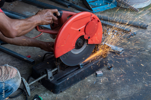 Worker cut steel with cut off wheel saw, cutting wheels.