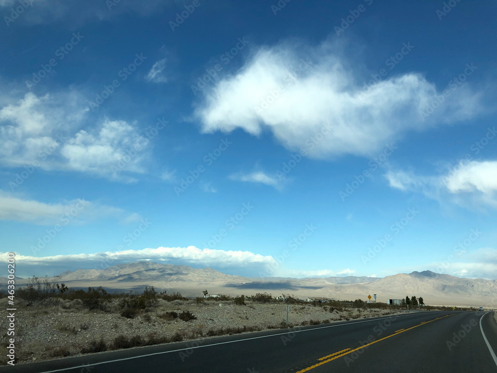 highway and mountains with blue sky and clouds