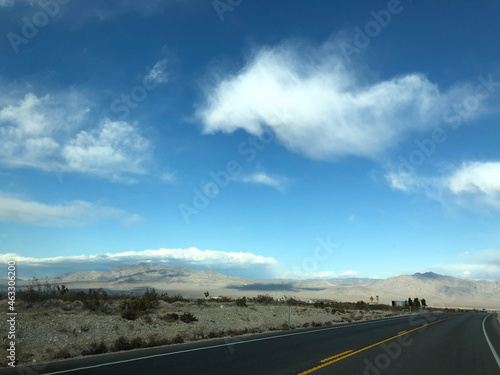 highway and mountains with blue sky and clouds