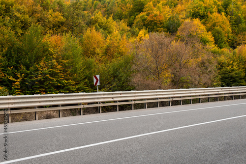 Highway and autumn landscape with vibrant fall colors. Empty mountain road in Turkey.