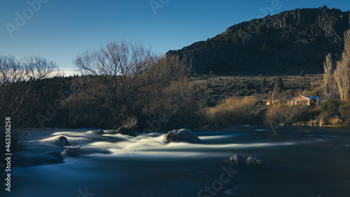 Long exposure river with house in the mountains