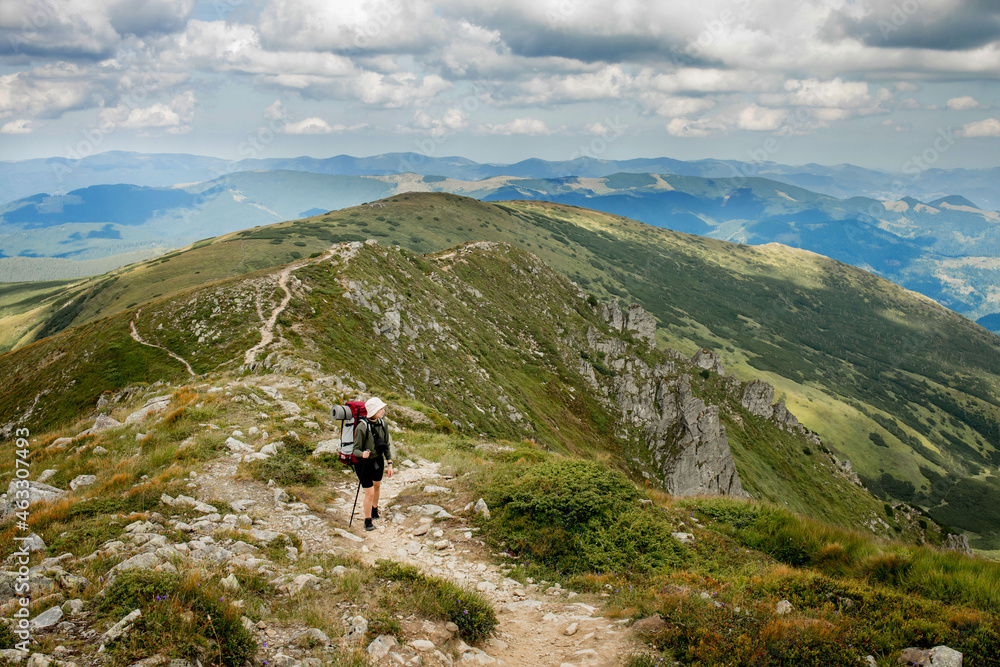 Hiker on the top in Carpathians mountains. Travel sport lifestyle concept.