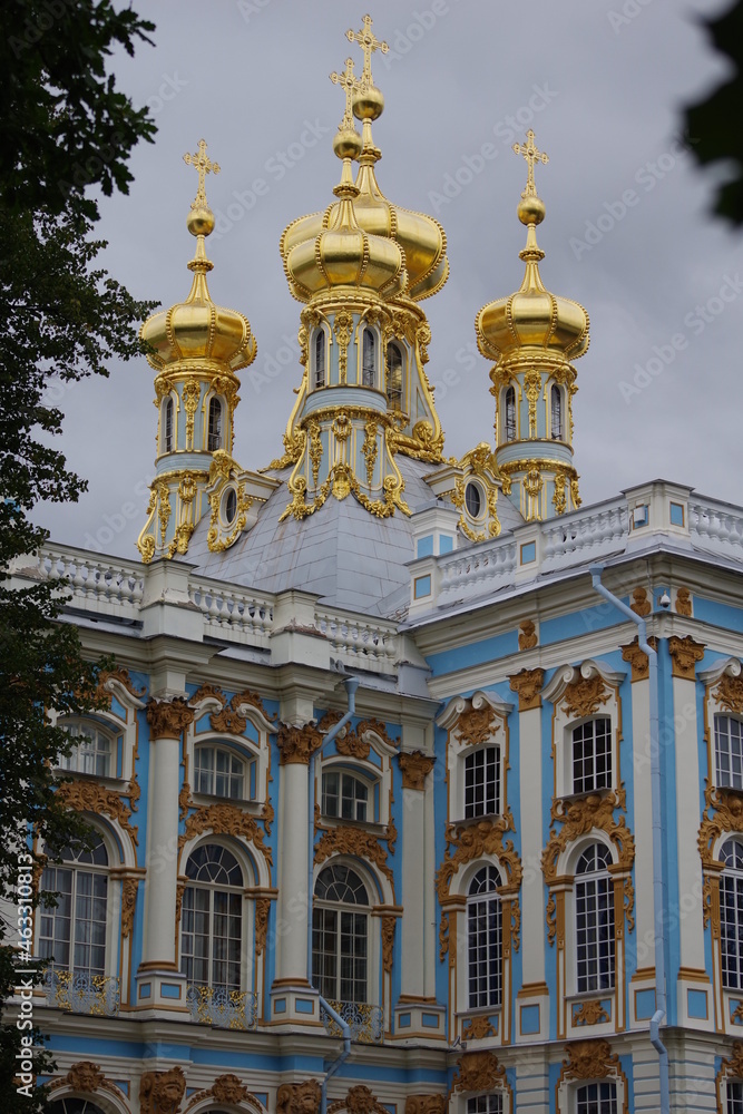 Golden domes of Church and details of facade of emperors palace in Tsarskoe selo museum in Saint Petersburg, Russia