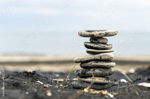 Photography Closeup of stacked flat stones on the ground with a blurry background