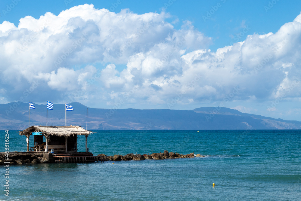 Crete island, Greece Agia Marina beach near Chania Small rock breakwater with cliffs and mountains on the horizon