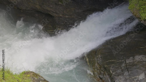 View of water rushing through the gate at a dam. The force of the water. Zwirgi Staudamm, Berner Oberland, Canton Bern, Switzerland. photo