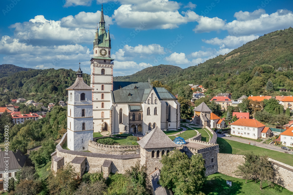 Aerial view of Gothic St. Caterina fortified church in Kremnica, surrounded by double walls, guard towers, gate tower, moat above the medieval walled town center guarding the gold mines in Slovakia Aerial view of Gothic St. Caterina fortified church in Kremnica, surrounded by double walls, guard towers, gate tower, moat above the medieval walled town center guarding the gold mines in Slovakia
