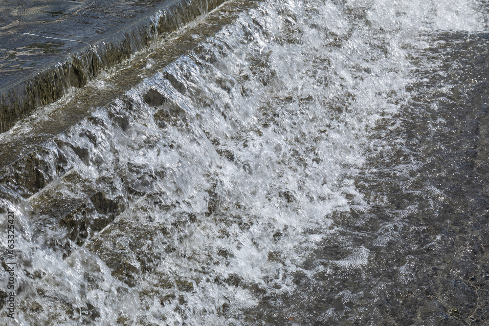 Cool water cascading down stairs of a public fountain to a pool, horizontal aspect Cool water cascading down stairs of a public fountain to a pool, horizontal aspect