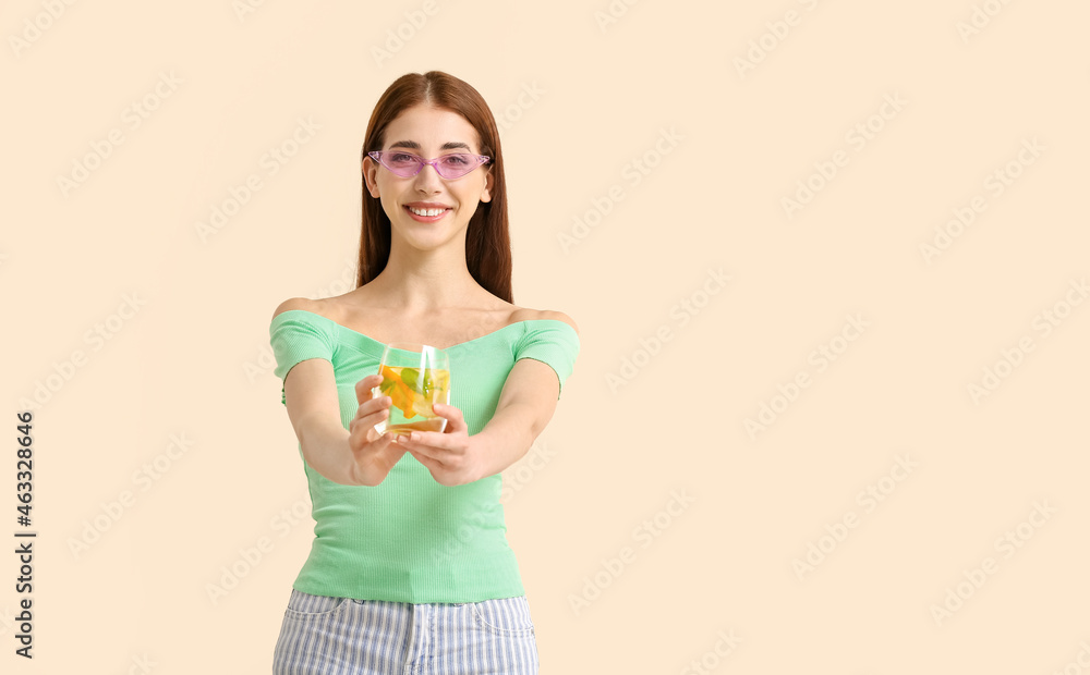 Beautiful young woman with fresh lemonade on light color background Beautiful young woman with fresh lemonade on light color background