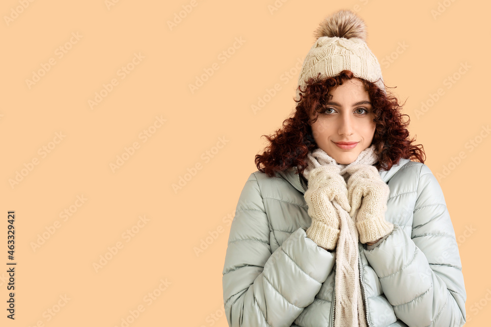 Frozen woman in winter clothes and knitted hat on color background Frozen woman in winter clothes and knitted hat on color background