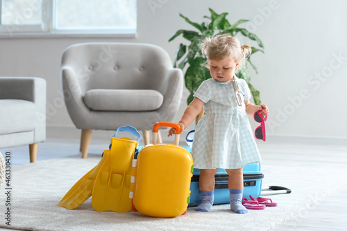 Cute baby girl with suitcas...