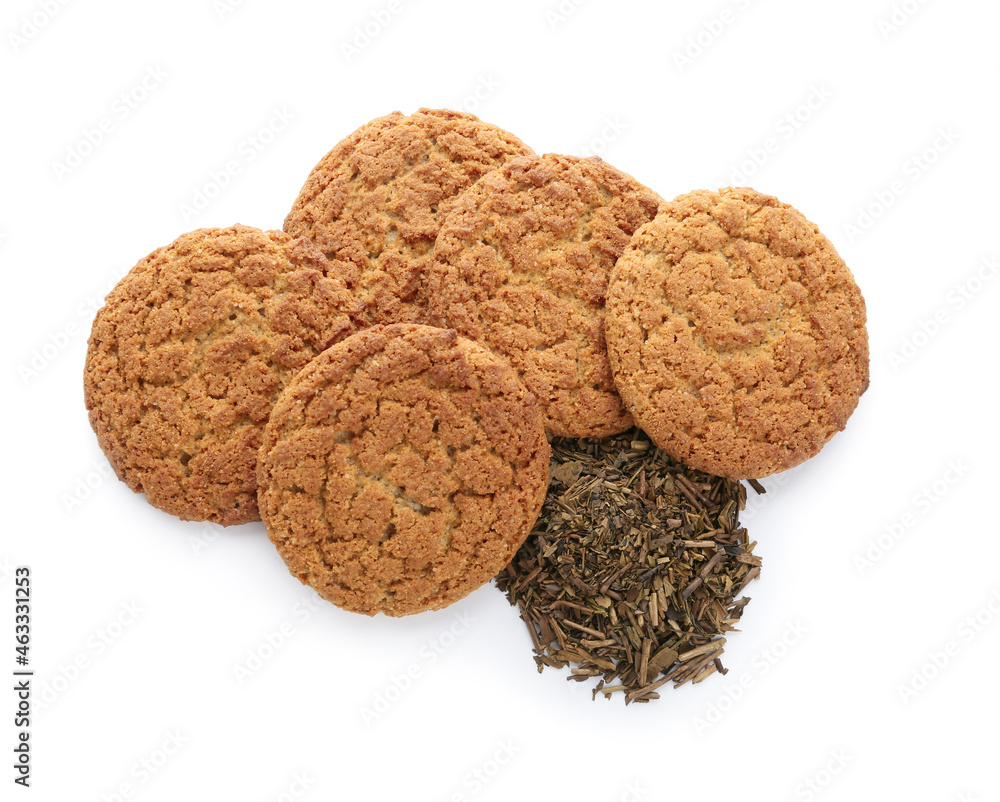 Tasty hojicha cookies and dry leaves on white background Tasty hojicha cookies and dry leaves on white background