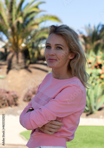 beautiful young blondie woman in pink portrait near the ocean