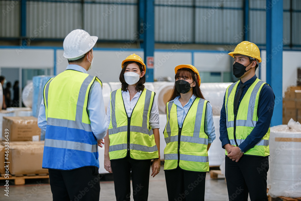 Teamwork engineer in uniform wear protection mask brainstorming workshop industrial factory building. meeting worker team. Teamwork engineer in uniform wear protection mask brainstorming workshop industrial factory building. meeting worker team.