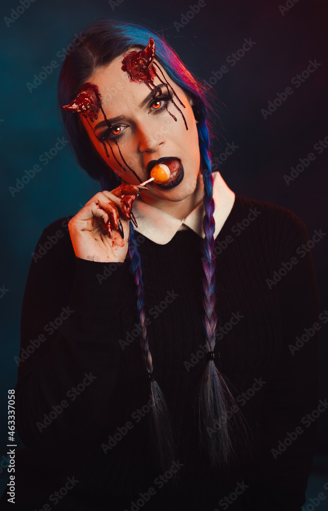 woman with scary halloween makeup with bloody horns dark background - obrazy, fototapety, plakaty 