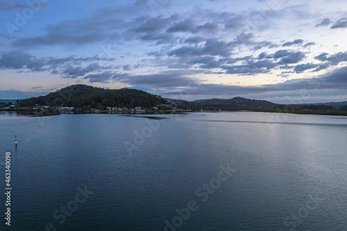 Sunrise waterscape with cloud covered sky