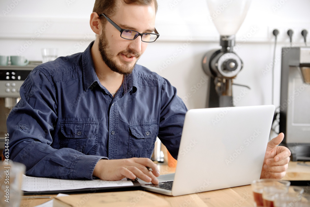 Man working on laptop at coffee shop Man working on laptop at coffee shop