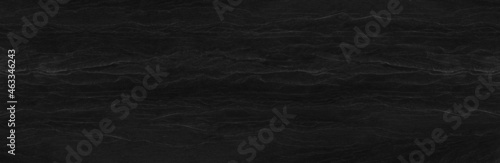 Panorama dark gray stone background with copy space. Black grunge banner with rock texture.