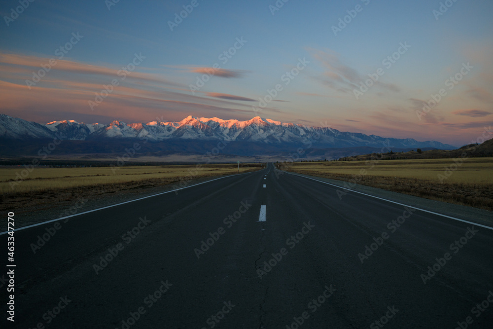 Classic panoramic view of the Altai Mountains on the beautiful Chuysky tract highway at dawn. Pink mountains at dawn.