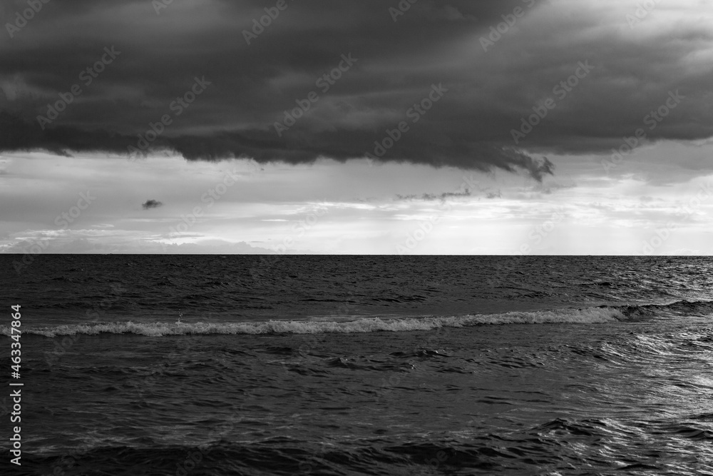 the sky in the clouds before the storm in Lake Onega in black and white