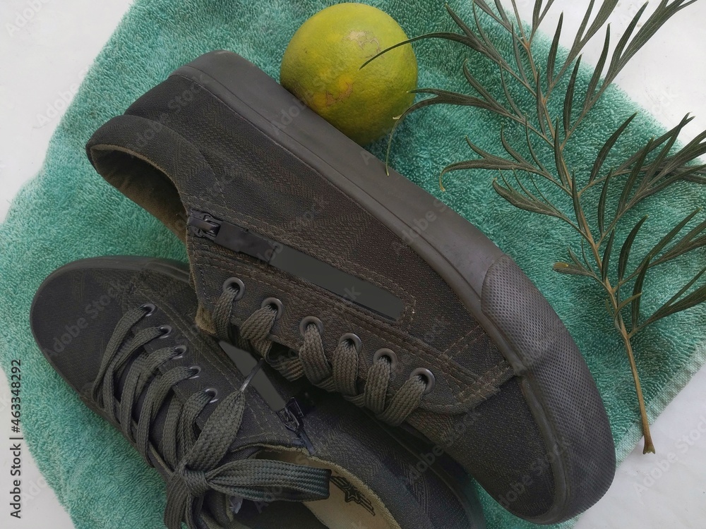 Dark green shoes with a textured background. Stock Photo | Adobe Stock