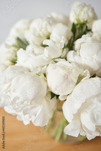White peonies in a glass vase. Beautiful peony flower for catalog or online store. Floral shop concept . Beautiful fresh cut bouquet. Flowers delivery