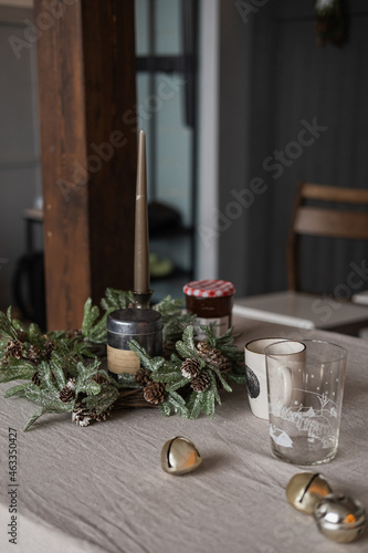 Scandinavian hygge home living room interior. Dinner table with Christmas decorations. Christmas dinner celebration preparation