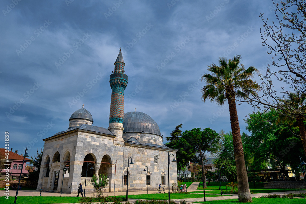 Fototapeta premium Outside and facade view of Green Mosque in iznik and palm tree. Old ottoman and byzantine city of Iznik Bursa. Turkey 27.04.2021.