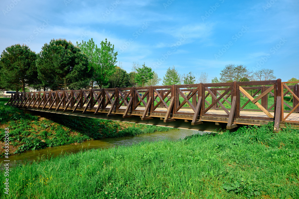 Wooden bridge, old small bridge made of wooden material by photo taken from its corner and blue sky background.