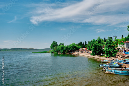 Golyazi, Bursa, Turkey. 29.4.2021. The lake of uluabat and magnificent sky and local small wooden made fishing boats standing on water's edge of the lake and blue sky background.