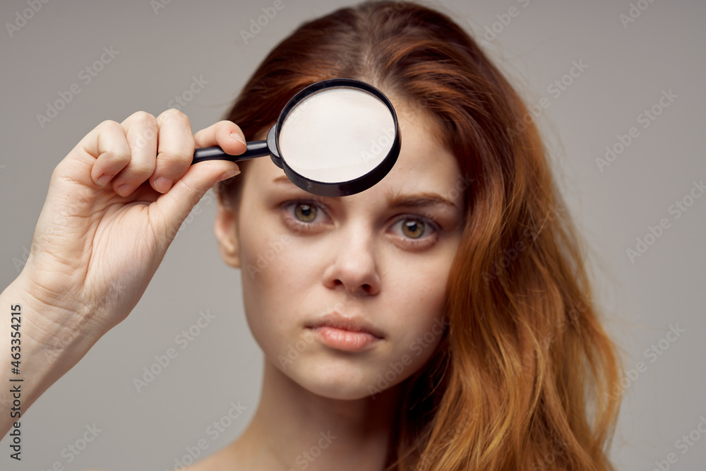 beautiful woman magnifier near the face hygiene close-up beautiful woman magnifier near the face hygiene close-up