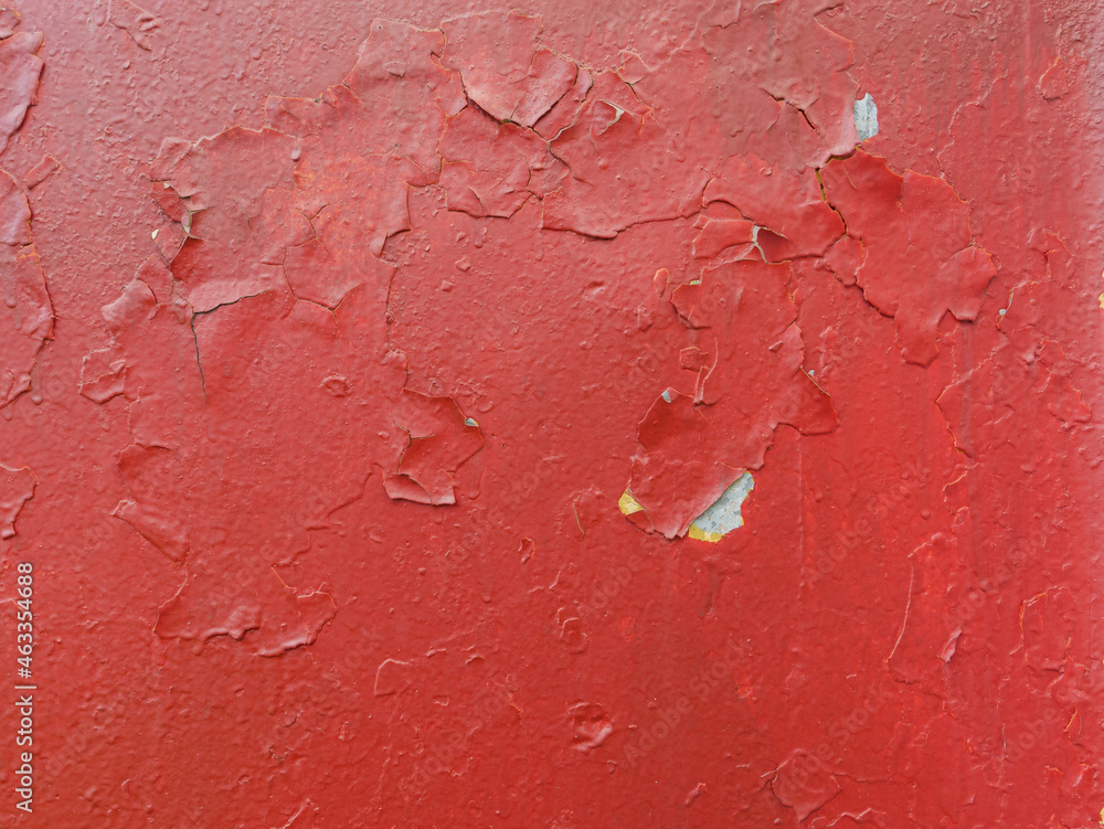 Peeling red paint on a metal surface. Peeling red paint on a metal surface.