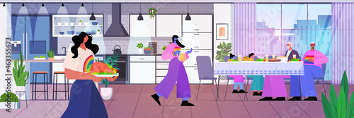 lesbian family with parents having lunch transgender love LGBT community concept kitchen interior horizontal