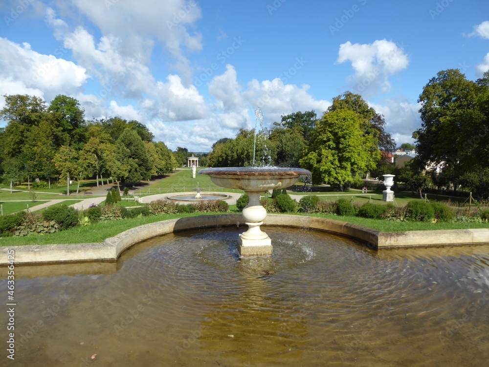 Fountain and pond in the park of Neustrelitz, Mecklenburg-Western Pomerania, Germany, in the background the Temple of Hebe
