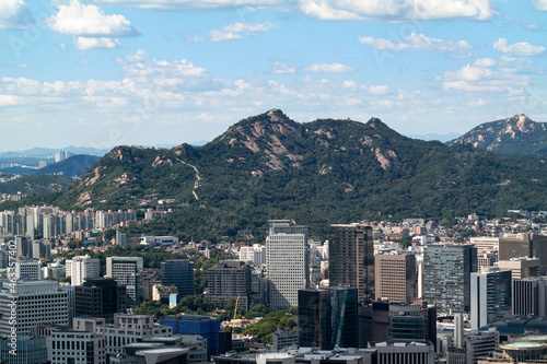 The cityscape of Jongno-gu district and the natural scenery of Inwangsan Mountain in Seoul, South Korea.