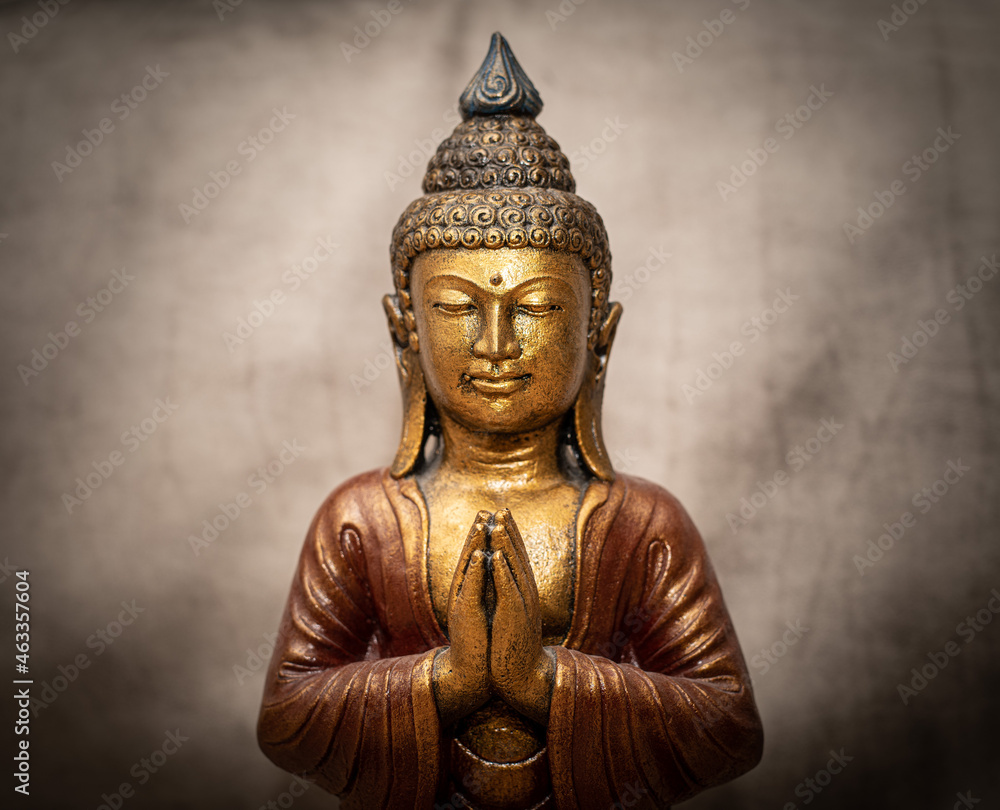 Golden Buddha on grey vintage background