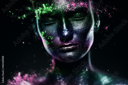 mystical woman in rainbow body art with pink and green crystals on face
