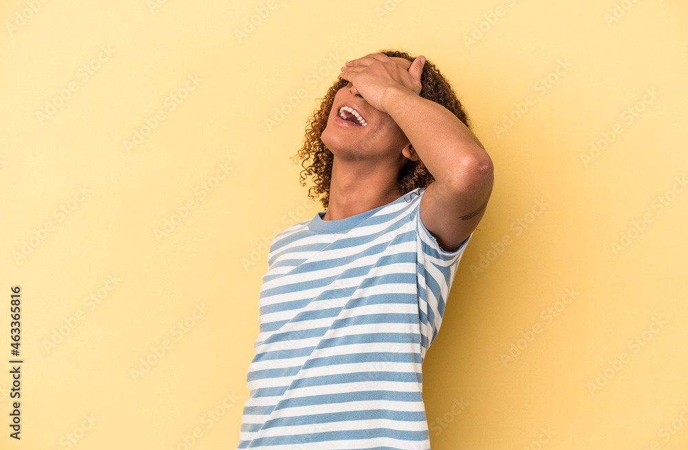 Young latin transsexual woman isolated on yellow background laughs joyfully keeping hands on head. Happiness concept. Young latin transsexual woman isolated on yellow background laughs joyfully keeping hands on head. Happiness concept.