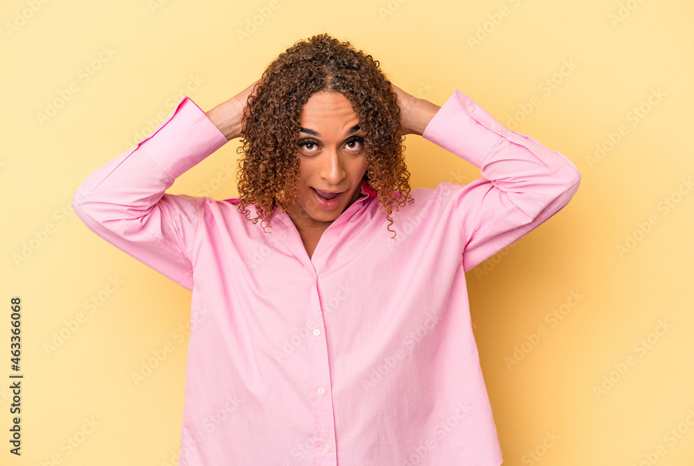 Young latin transsexual woman isolated on yellow background screaming, very excited, passionate, satisfied with something. Young latin transsexual woman isolated on yellow background screaming, very excited, passionate, satisfied with something.
