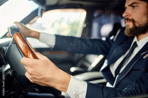 businessmen in a suit in a car a trip to work communication by phone