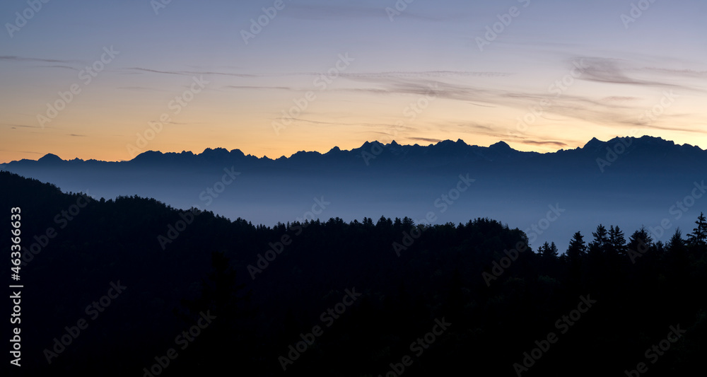 Forest and silhouette of mountains in the morning