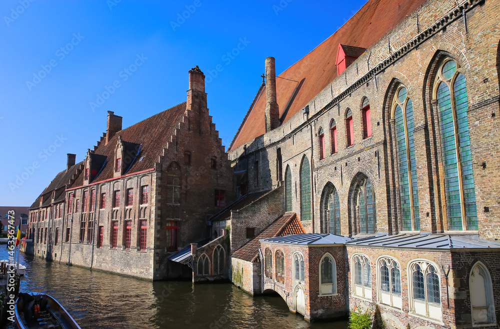 Brugge (Sint Jans Hospital), Belgium - October 9. 2021: View over water canal on medieval brick gothic hospital building