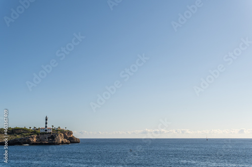 General view of the lighthouse of the Majorcan town of Portocolom, at dawn on a sunny day. Maritime navigation image © Nemesio